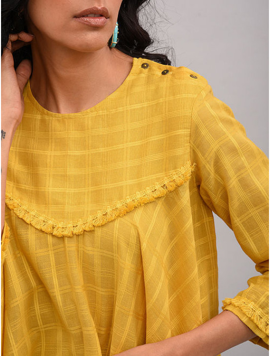 A asymmetrical top with 3/4th sleeves and yoke decorated with soft cotton tassel lace 